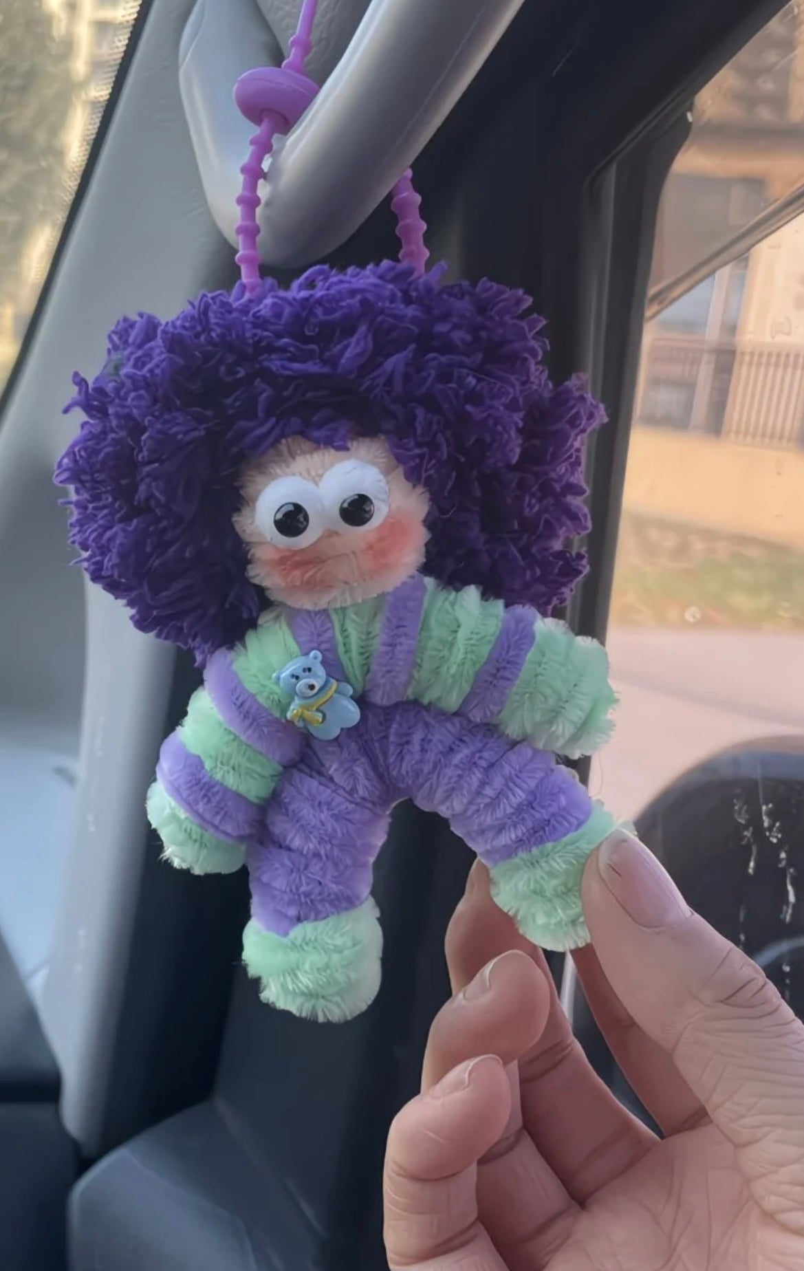 Handmade mystery doll charm on backpack – chenille stem wool yarn keychain decoration2
