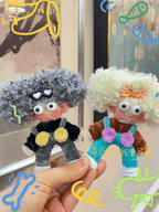 Handmade mystery doll charm on backpack – chenille stem wool yarn keychain decoration
